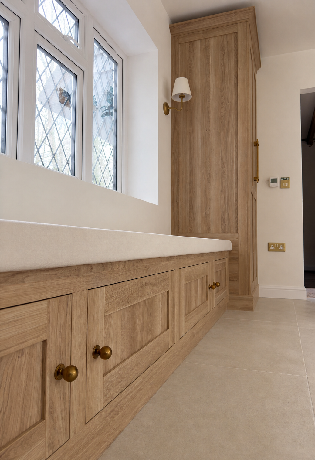 Cream panelled fitted wardrobes in a light-filled bedroom